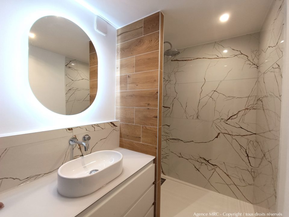 Vasque et plan de travail marbre dans une salle de bain premium, associations matières nobles